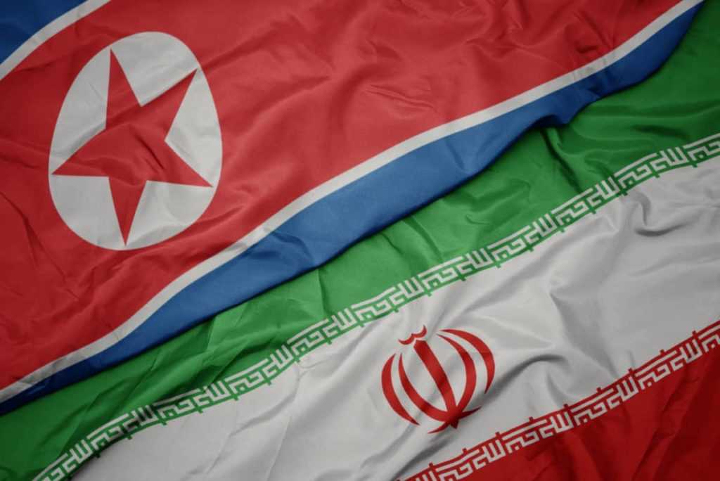 waving colorful flag of iran and national flag of north korea.