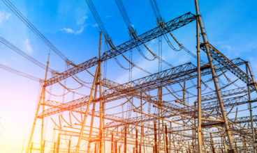 High voltage electricity tower at sunset.substation industrial background.