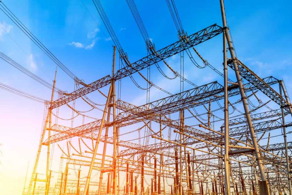 High voltage electricity tower at sunset.substation industrial background.