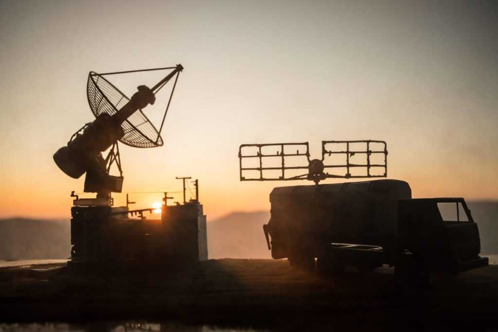 Satellite dishes or radio antennas against evening sky. Selective focus