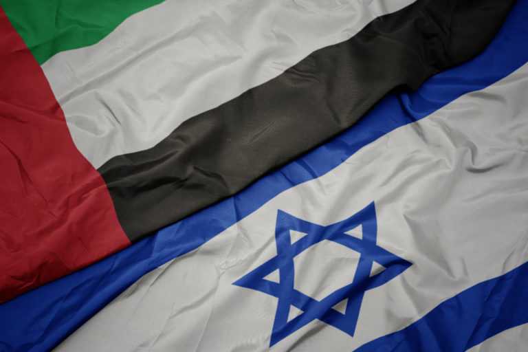 waving colorful flag of israel and national flag of united arab emirates.