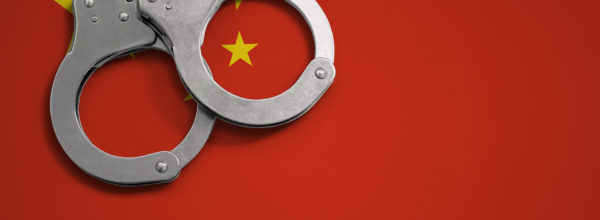 China flag  and police handcuffs. The concept of crime and offenses in the country