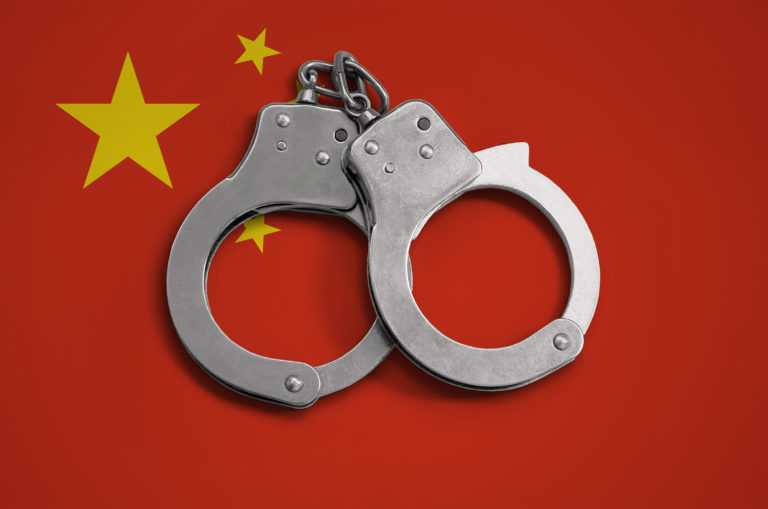China flag  and police handcuffs. The concept of observance of the law in the country and protection from crime