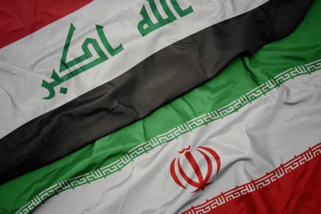 waving colorful flag of iran and national flag of iraq.