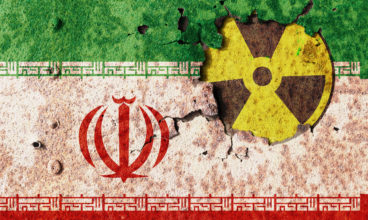 Iran flag on metal wall. Conflict of atomic technology