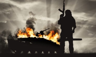 Armed terrorist and burning tank