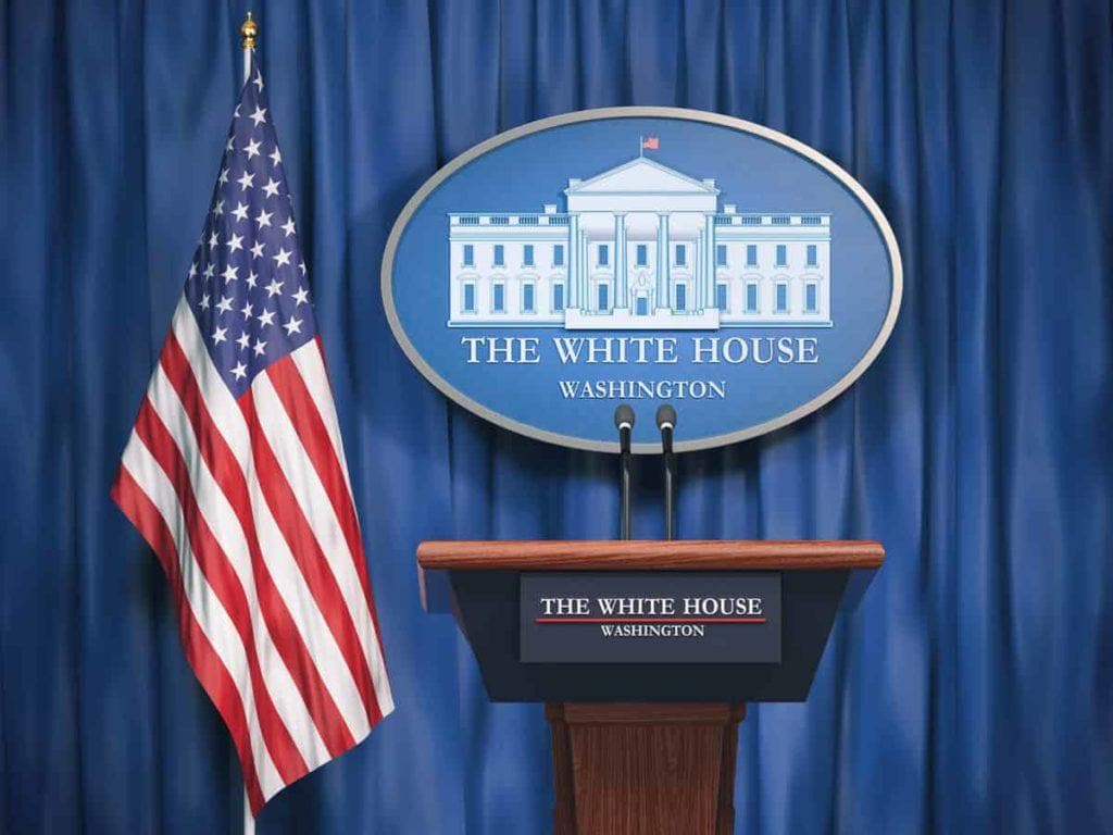 Politics of White House and President of USA United states concept.  Podium speaker tribune with USA flags and sign of White House