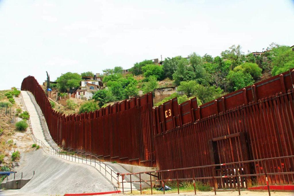 Border Fence beside a street in downtown Nogales, Arizona separating the United States from Mexico.