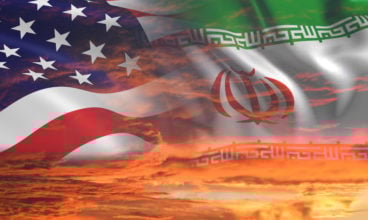 USA United States of America and Iran relations - iran us war with flags on stormy cloudy orange sky background