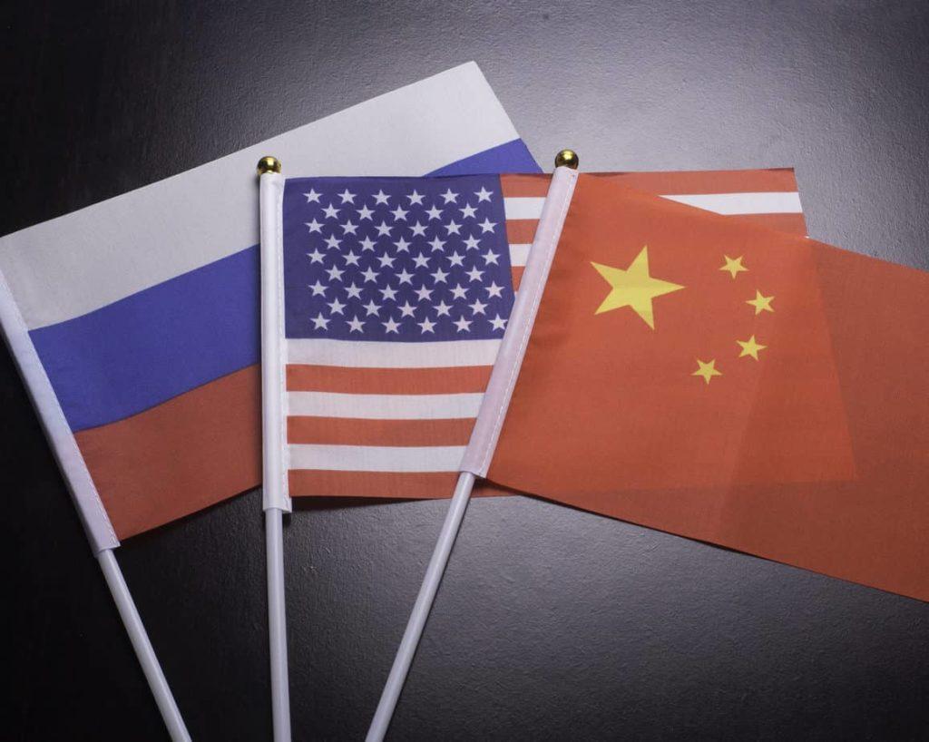 Flags of Russia,China,Iran and the USA show the relationship between the two countries .