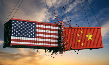 USA and China trade war. US of America and Chinese flags crashed containers on sky at sunset background. 3d illustration