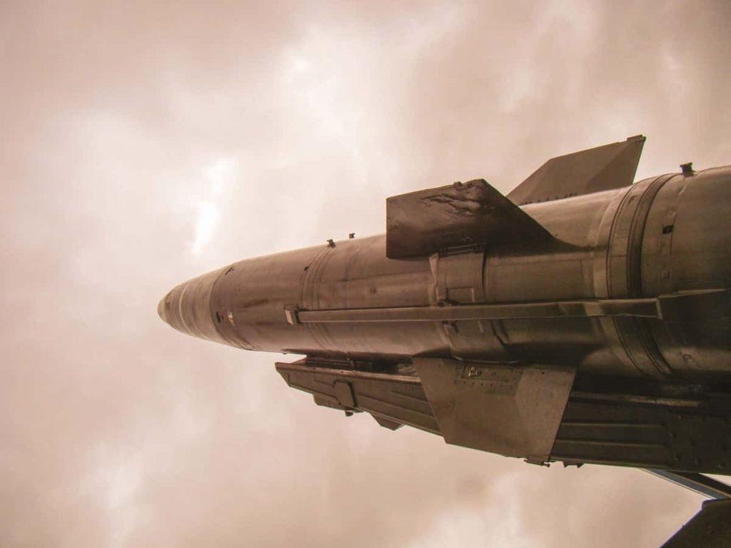 A military missile is ready for launch on a background of a threatening sky. Stabilizers. The concept of war, conflict, threats. "deliberately blurred"