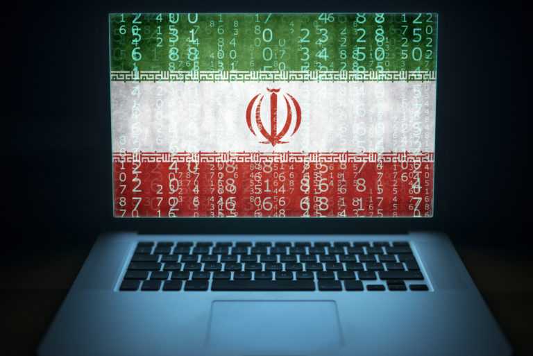 Iran internet and network security. Laptop with binary computer code and Iranian flag on the screen. Iranian hacker.