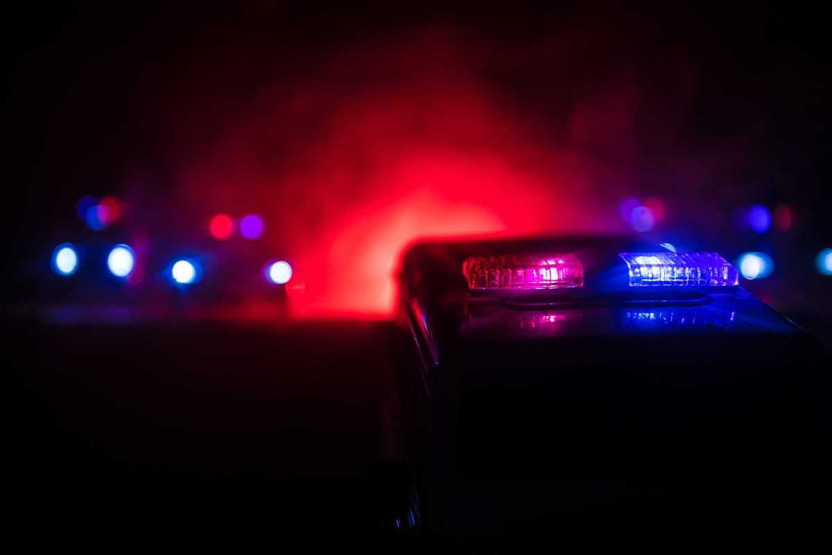 Police cars at night. Police car chasing a car at night with fog background. 911 Emergency response pSelective focus