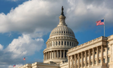 US Capitol Building with American flags is the home of the United States Congress in Washington D.C, USA.