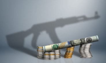 defense budget concept, money with gun shadow